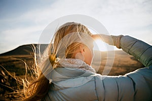 Close up of Caucasian female hiker looking at the view on top of a mountain