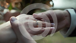 Close-up, caucasian man hands put gold wedding ring on woman finger