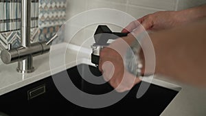 Close-up, Caucasian man pouring coffee into horn with spoon and pressing it