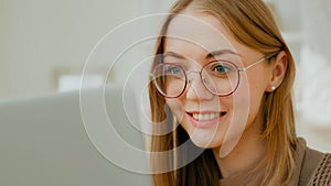 Close up Caucasian woman female face girl in glasses eyes look at laptop screen. Freelancer smiling businesswoman busy