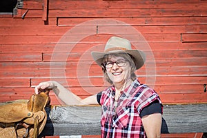 Close up of caucasian woman wearing cowboy hat with saddle