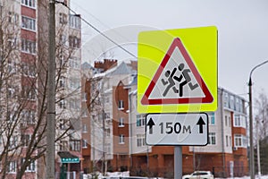 Close-up of caution children road sign in a residential area.