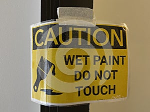 Close up caution wet paint sign on the wall