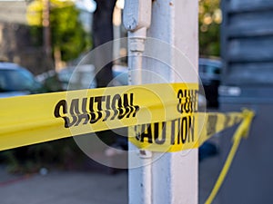 Close up of caution yellow trap hanging on a pole and blocking a path