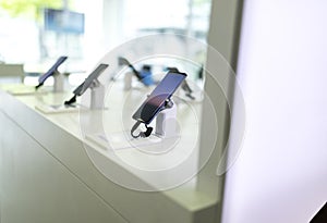 Close up of cell phones or mobile phones on display in a modern, clean and contemporary shop or mall