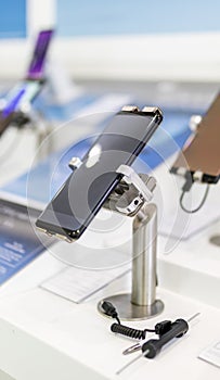 Close up of cell phones or mobile phones on display in a modern, clean and contemporary shop or mall