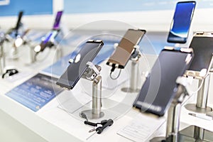 Close up of cell phones or mobile phones on display in a modern, clean and contemporary shop or mall