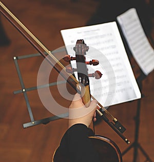 Close up of cello with bow in hands