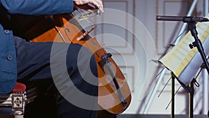 Close-up of a cello player bowing his instrument