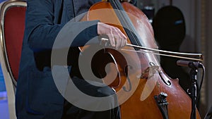 Close-up of a cello player bowing his instrument