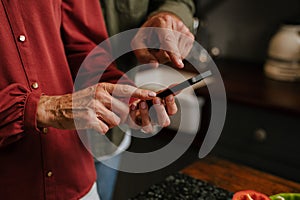 close up cellphone caucasian senior couple texting