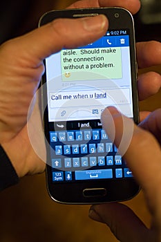 Close Up of Cellular Phone Text Messages About Travel