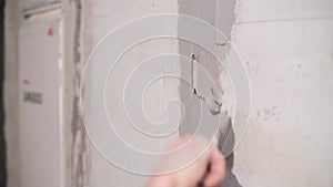 Close-up of cement mortar getting on unevenness in the wall.