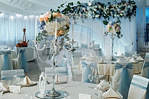 Close up of centerpiece at wedding reception. Luxury elegant table setting dinner in a restaurant