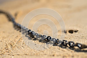 Close up of an chain on a beach