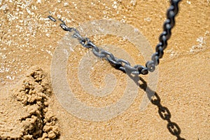 Close up of an chain on a beach