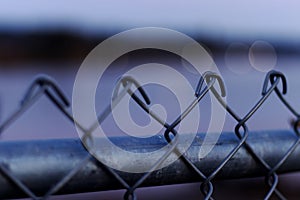 Close up of chain link fence with a blurred background