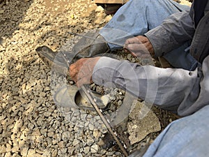 Close-up of chainsaw blade being sharpened