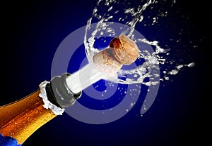 Close up of champagne cork popping photo