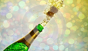 Close up of champagne cork popping on bokeh background