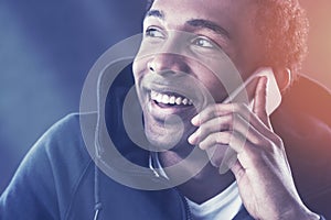 Close up of cheerful African man on phone