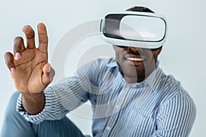 Close up of cheerful man using VR glasses