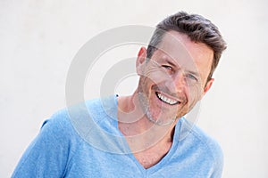 Close up cheerful older man standing on white background