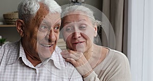 Close up cheerful older spouses talking laughing hugging indoor