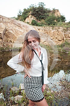 Close-up of cheerful woman with tousled hair. Happy young female . She is against mountains nature.