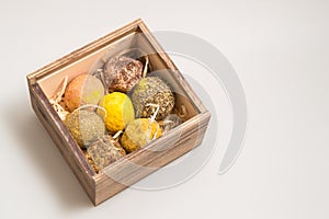 Close up. Cheese dwarf. Swiss cheese balls rolled in herbs and spices. A set of craft cheese in a wooden box. Copy space