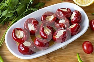 Close-up cheese filled cherry peppers on wooden background. photo