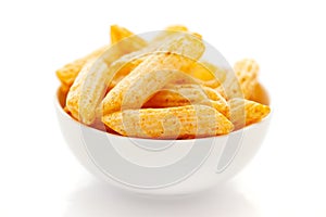 Close up of Cheese Puff Snacks cream color, Popular Ready to eat crunchy and puffed snacks cheesy salty pale-yellow color over