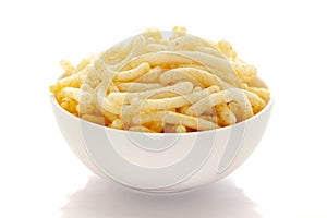 Close up of Cheese Puff Snacks cream color, Popular Ready to eat crunchy and puffed snacks cheesy salty pale-yellow color over