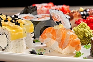 Close up of cheese rolls and sake nigiri. photo