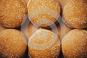 Close-up of cheeseburgers or hamburgers on a wooden background. Food background. Buns with sesame