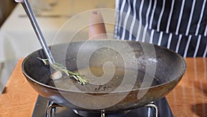 Close-up of chef cooking flambe style dish with slices of liver on a hot frying pan in restaurant. Slow motion.