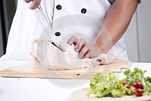 Close up Chef prepared cutting chicken breast