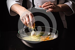 close-up of chef& x27;s hands mixing and stirring ingredients for delicious dish