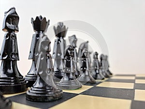 Close-Up Of Chess Pieces On Chessboard Game Beginning