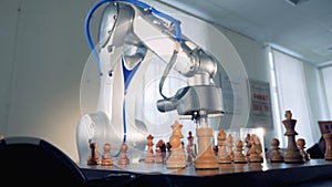 Close up of chess pieces getting relocated and removed during the game between human and robot