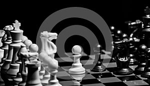 Close up of Chess pieces on a reflective mirror board surface wi