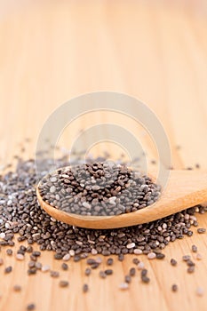 Close up of Chia seeds in a wooden spoon on the table