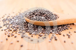 Close up of Chia seeds in a wooden spoon on the table