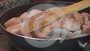 Close up of a chicken meat cooking in the frying pan.