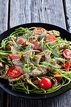 Close-up of chicken zucchini pasta tomato salad
