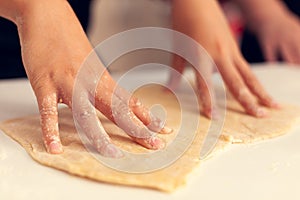 Close up of child doing dough for dessert on christmas day