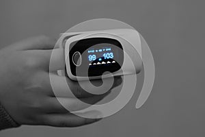 Close-up for a child hand with a pulse oximeter that measures the oxygen saturation of the blood and the pulse rate
