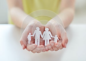 Close up of child hands with paper family cutout