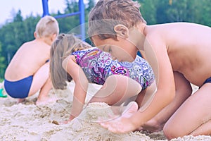 Close-up of a child hands, playing in the sand on the beach