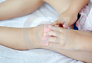 Close Up of child knee with a plaster for woundsClose Up of child knee with a plaster for wounds